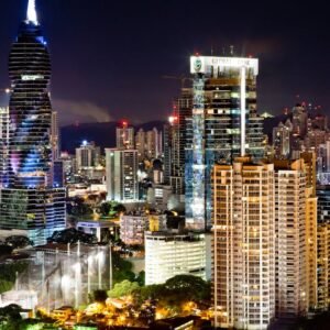 Illuminated skyscrapers under a moonlit sky in Panama City's vibrant urban landscape.